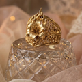 Decorative crystal jar with a gold zolthaire floral ring on a soft beige background