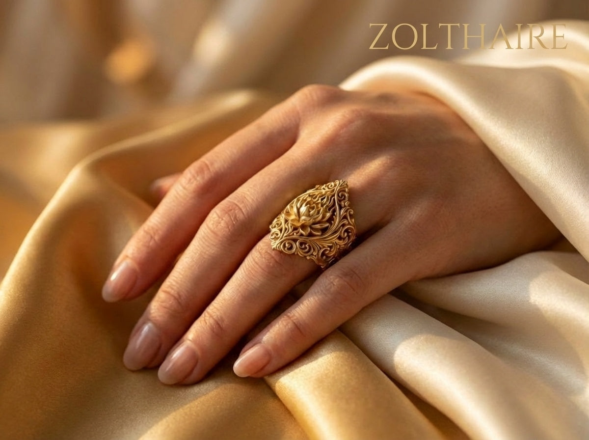 Hand wearing a gold ring on beige fabric